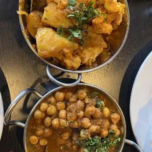 three bowls of indian food on a table