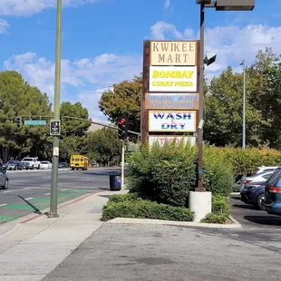 a street corner with cars parked on the side of the road