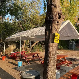 a picnic area with tables and umbrellas
