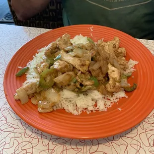 Chicken kebab with tzatziki sauce on the side.