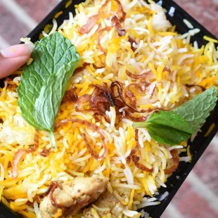 a person holding a tray of food