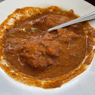 a plate of food with a spoon