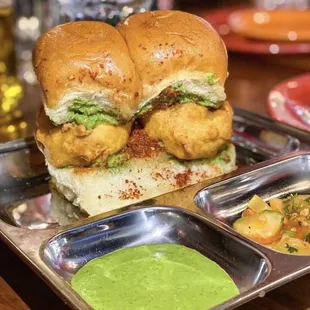 a chicken sandwich with a side of guacamole