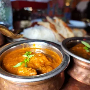 a bowl of curry and a plate of rice