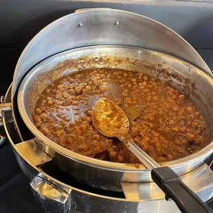 a pot of beans and a spoon