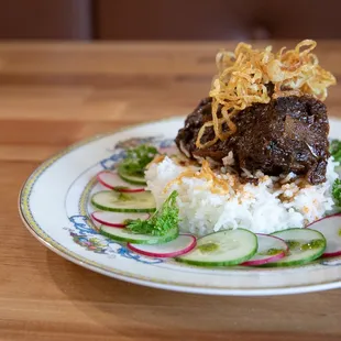 a plate of food on a wooden table