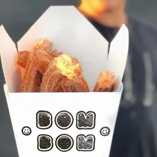  person holding a box of doughnuts