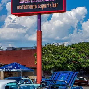 a classic car parked in a parking lot