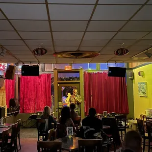 people sitting at tables in a restaurant
