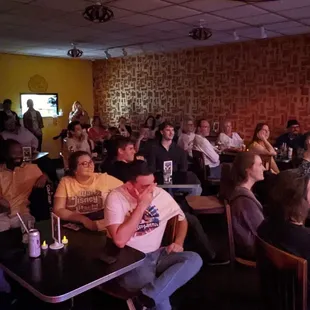 a crowd of people sitting at tables