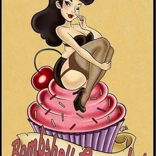 a woman sitting on top of a cupcake