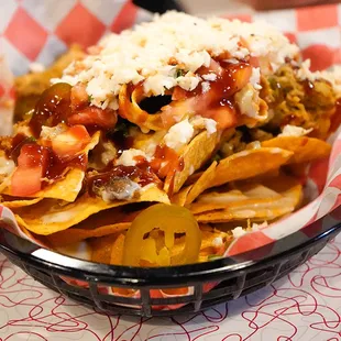 Our famous Loaded Fries are topped with Smoked Pulled Pork, Queso, and Aunt Connie&apos;s Cole Slaw