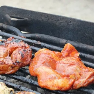 a closeup of a bbq with meat on it