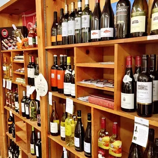 a shelf full of wine bottles