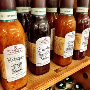 a shelf full of pickles and sauces