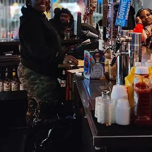 a woman behind the bar