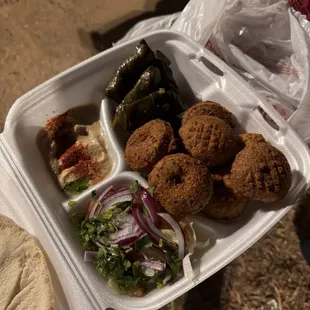 Falafel and dolma with salad and hummus.