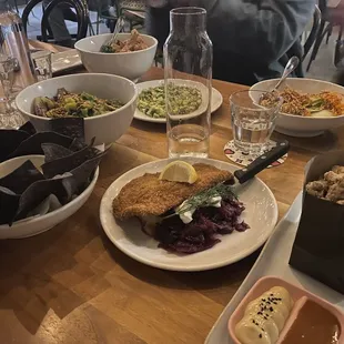 a wooden table with plates of food on it