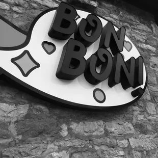 a black and white photo of a sign for bon bon