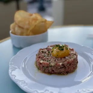 Steak Tartare w/ cornichons, capers, potato chips ($18)