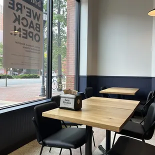 a table and chairs in front of a window