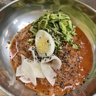 a bowl of soup with a hard boiled egg