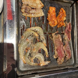 a variety of food on a grill