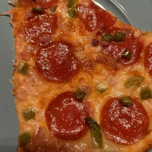 a slice of pepperoni pizza on a plate