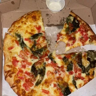 a pizza in a box with a slice taken out of it