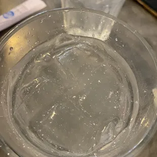 a glass of water and a toothbrush