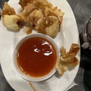 a plate of dumplings and dipping sauce