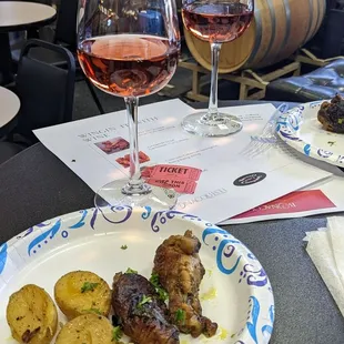 two glasses of wine and a plate of food