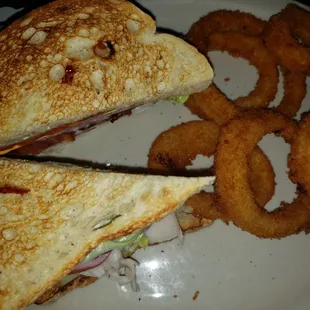 a sandwich and onion rings on a plate