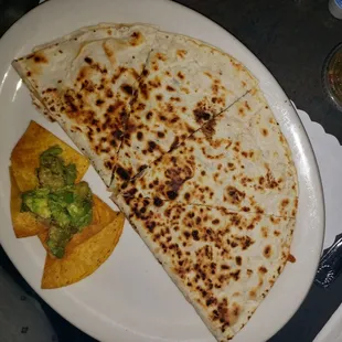 a quesadilla and chips on a plate