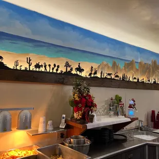 a desert scene painted on the wall