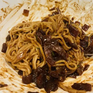 a dirty plate of noodles