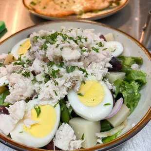 a plate of salad with hard boiled eggs