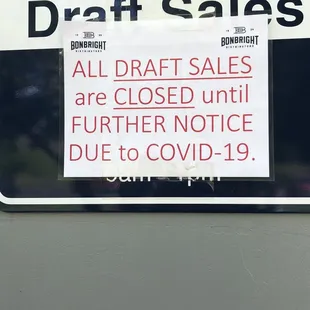 a sign on a wall stating all draft sales are closed until further notice due to covidid 19