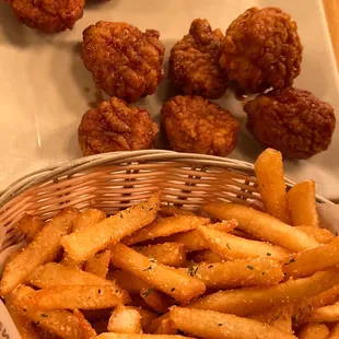 a basket of fried chicken nuggies and french fries