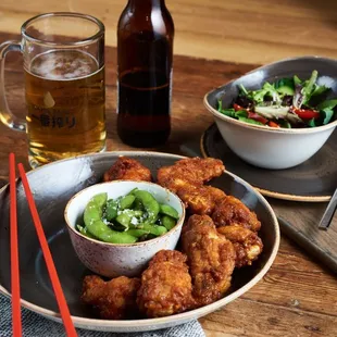 a plate of fried chicken and a bowl of salad