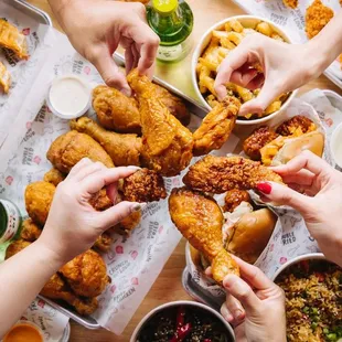 a table full of fried chicken and other food items