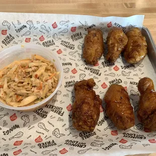 Wings with soy garlic and korean bbq sauce and a side of kimchi cole slaw.
 Yum