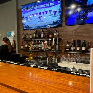 a bar with a large screen tv in the background