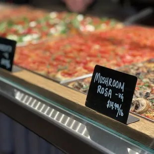 a variety of pizzas on display