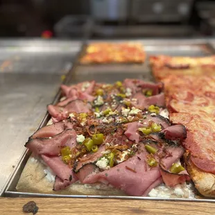 a variety of pizzas on a table