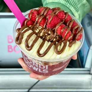 a hand holding a smoothie