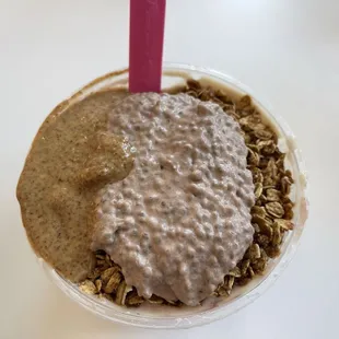 Small acai bowl with almond butter, chocolate chia pudding, pre-probiotics, and granola