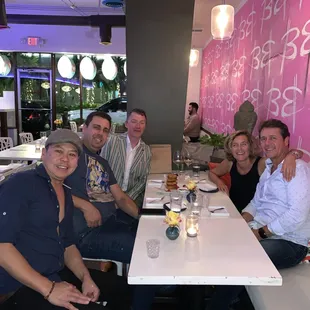 Partners having a drink with guests