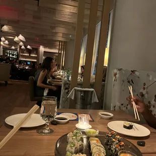 Sushi plate and view of middle of restaurant