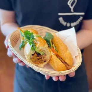 #9 Pork Banh Mi - check out our other protein options! Garnished w/ pickled carrots and daikon, cucumber, onions, cilantro, &amp; jalapeños.